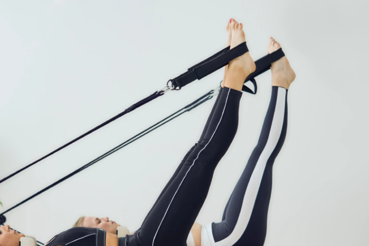Pratiquantes utilisant les sangles de pieds sur Reformer